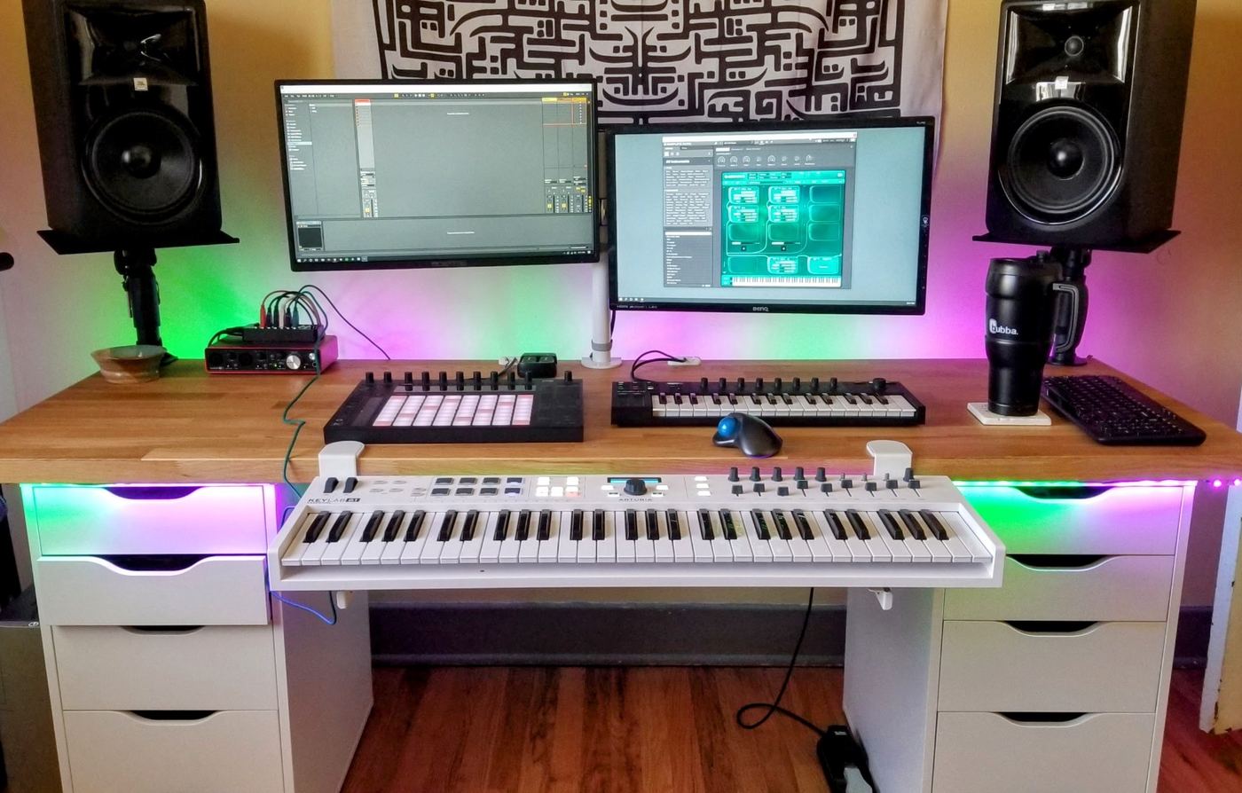 The founder's home music studio: keyboard, monitors, and color-lit desk